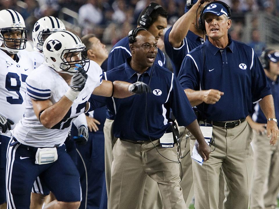 BYU defensive coordinator Jaime Hill sends linebacker Shawn Doman (left) to the field during BYU’s victory over Oklahoma on Sept. 5, 2009. The Cougars upset the Sooners 14-13.