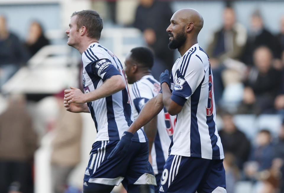 FILE - This is a Saturday, Dec. 28, 2013. file photo of West Bromwich Albion's Nicolas Anelka, right, as he gestures to celebrates his goal against West Ham United during their English Premier League soccer match at Upton Park, London. It's caught on like a dance move one hand pointing downward, the other touching the shoulder with arm across the chest. But for many, the gesture is a hateful, anti-Semitic code. France’s top security official wants the entertainer who popularized it banned from the stage. Dieudonne M'Bala M'Bala, who has performed for more than two decades and has a small but faithful following, contends the gesture, dubbed the quenelle, is no more than an anti-system sign, the equivalent of "shove it." Soccer star Nicolas Anelka used it on Saturday Dec. 28to celebrate a goal, and basketball star Tony Parker did likewise. Both said they did not understand it was an anti-Semitic gesture. Parker said in his mea culpa contained in a statement released by the San Antonio Spurs that he "thought it was part of a comedy act." (AP Photo/Sang Tan, File)