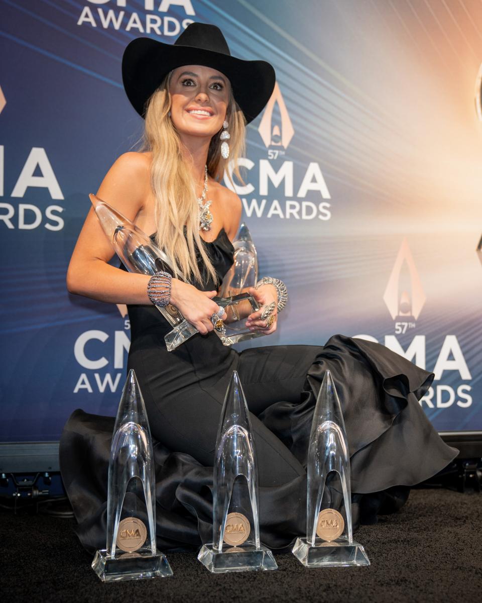 Lainey Wilson poses with her awards in the backstage media center during the 57th Annual Country Music Association Awards in Nashville, Tenn., Wednesday, Nov. 8, 2023.