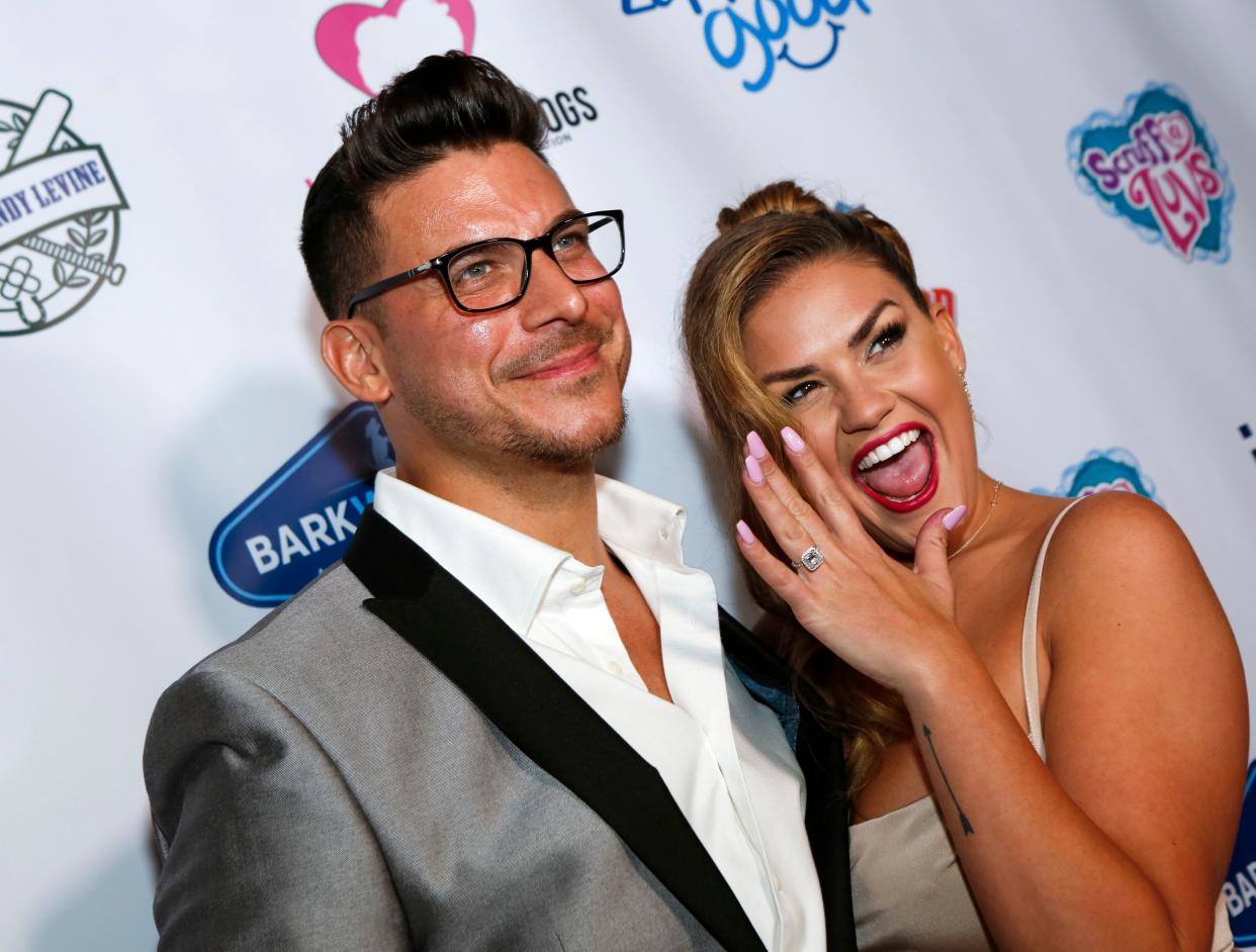 Jax Taylor and Brittany Cartwright smile at the camera with Brittany showing off her ring