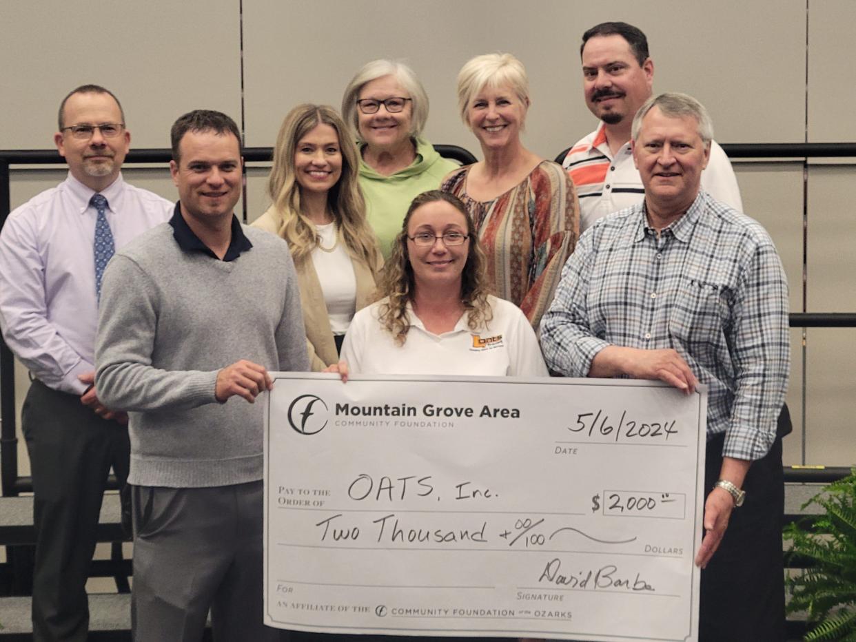 Driver Julie Vandivort, center, was presented with a check by members of the Community Foundation of the Ozarks–Mountain Grove Area Community Foundation.