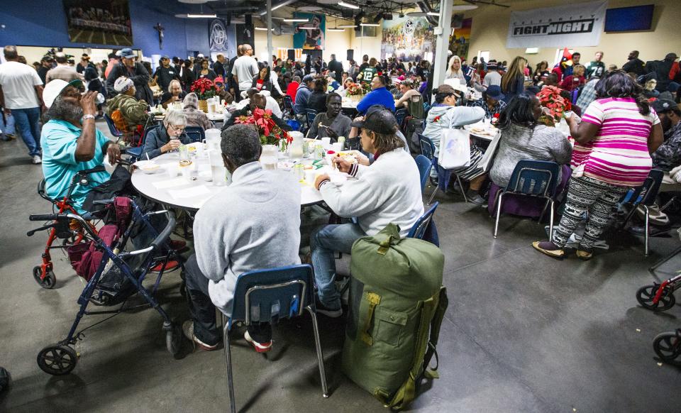 Hundreds enjoy a Thanksgiving Day meal served by volunteers at the St. Vincent de Paul Society Human Services Campus Dining Room in Phoenix, Thursday, November 22, 2018.   Turkey, mashed potatoes and pumpkin pie were on the menu.