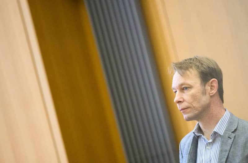 The accused Christian B. stands in the courtroom at Braunschweig Regional Court. Christian B. is accused of three cases of aggravated rape and two cases of sexual abuse of children in Portugal. Julian Stratenschulte/dpa Pool/dpa