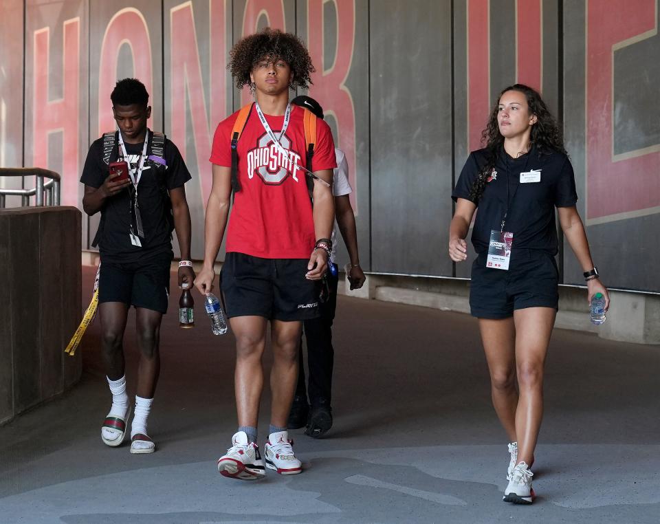 April 15, 2023; Columbus, Ohio, USA;  Ohio State football 2025 recruit Justin Hill, center, walks down the tunnel toward the field at Ohio Stadium before the Ohio State spring football game Saturday.Mandatory Credit: Barbara J. Perenic/Columbus Dispatch