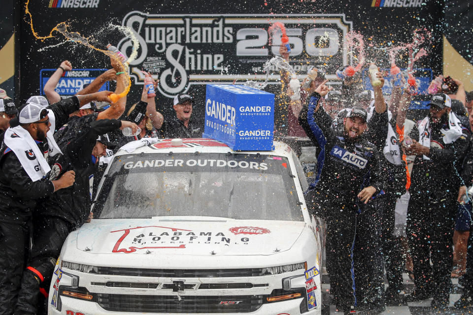 Camping World Truck Series driver Spencer Boyd (20) celebrates in Victory Lane after being declared the winner as driver Johnny Sauter (13) was disqualified during the Sugarlands Shine 250 at Talladega Superspeedway, Saturday, Oct 12, 2019, in Talladega, Ala. (AP Photo/Butch Dill)