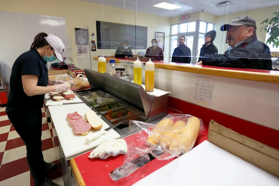 Owner Patti O’Leary makes sandwiches for the lunch rush on Feb. 1, 2022 at the Moe’s Italian Sandwiches in Exeter.