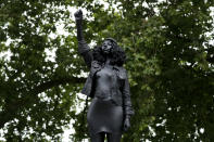 A new black resin and steel statue entitled "A Surge of Power (Jen Reid) 2020" by artist Marc Quinn stands after the statue was put up this morning on the empty plinth of the toppled statue of 17th century slave trader Edward Colston, which was pulled down during a Black Lives Matter protest in Bristol, England, Wednesday, July 15, 2020. On June 7 anti-racism demonstrators pulled the 18-foot (5.5 meter) bronze likeness of Colston down, dragged it to the nearby harbor and dumped it in the River Avon — sparking both delight and dismay in Britain and beyond. (AP Photo/Matt Dunham)