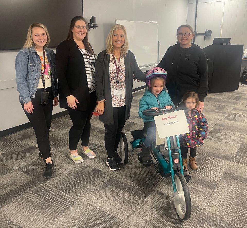 Kaidence Firestone, center, proudly sits on the new adaptive bike she received on April 4 from Variety, the Children's Charity and the Hidden Valley Foundation. Standing next to her, left to right, are: Kelsey Walker, Emily Hettinger and Kara Madara, all from Appalachia IU8; on her right are her mom, Ashley Firestone, and her sister, Macy. The Firestones live in Somerset.