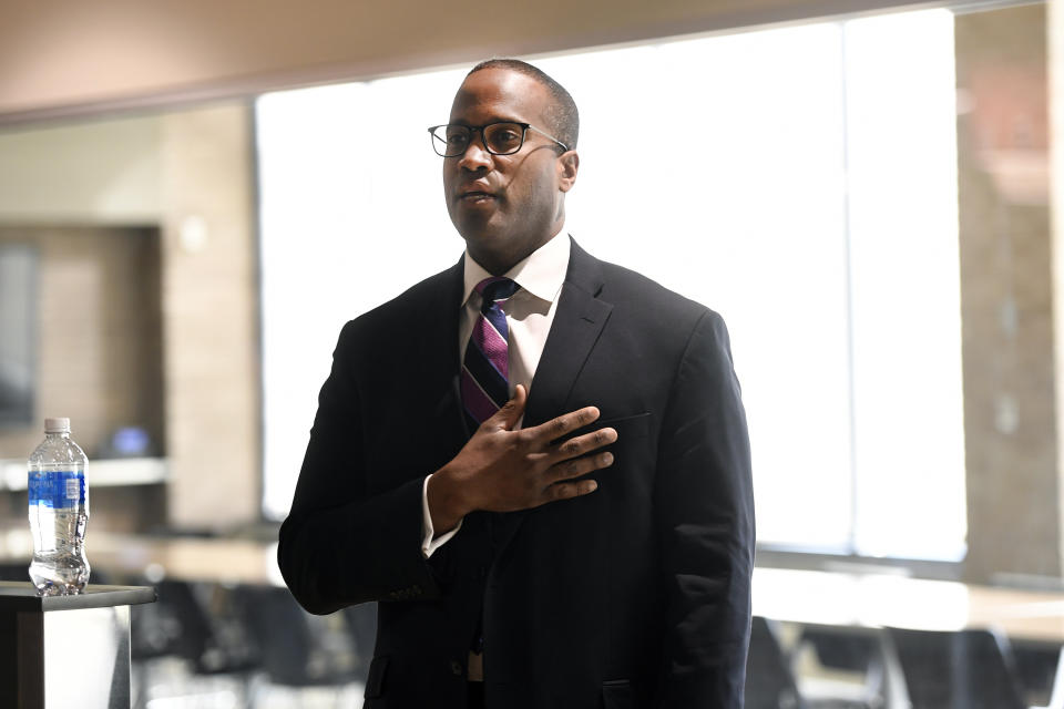 Rep. John James, R-Mich, recites the Pledge of Allegiance before being sworn into office, Friday, Feb. 24, 2023, in Warren, Mich. James is opting against a campaign for the Senate seat being vacated by Democrat Debbie Stabenow in 2024. James filed paperwork Friday to run for reelection to his Detroit-area House seat. (AP Photo/Jose Juarez)