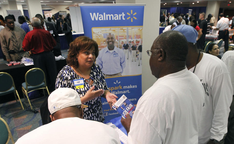 Job candidates receive information about employment at Walmart at a U.S. Congressional Black Caucus Jobs Fair in Miami, Florida August 23, 2011.  REUTERS/Joe Skipper  (UNITED STATES - Tags: EMPLOYMENT BUSINESS)