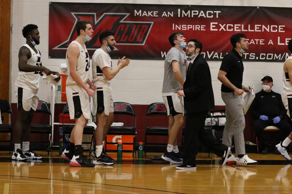 Arlington High School grad Sean McGee walks the Manhattanville College men's basketball sideline during a Jan. 12, 2022 game against USMMA. The 23-year-old made his head coaching debut, filling in for Chris Alesi, who had tested positive for COVID.