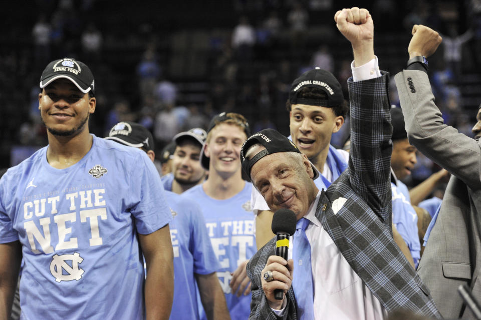 North Carolina head coach Roy Williams, right, celebrates with his team after beating Kentucky 75-73 in the South Regional final game in the NCAA college basketball tournament Sunday, March 26, 2017, in Memphis, Tenn. (AP Photo/Brandon Dill)
