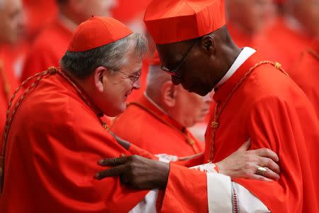 Cardinal Raymond Leo Burke (L) greets Cardinal Jean Zerbo (R) during a consistory as Pope Francis elevates five Roman Catholic prelates to the rank of cardinal, at Saint Peter's Basilica at the Vatican, June 28, 2017. REUTERS/Alessandro Bianchi