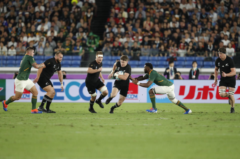 New Zealand's Beauden Barrett tries to avoid a tackle during the Rugby World Cup Pool B game between New Zealand and South Africa in Yokohama, Japan, Saturday, Sept. 21, 2019. (AP Photo/Shuji Kajiyama)