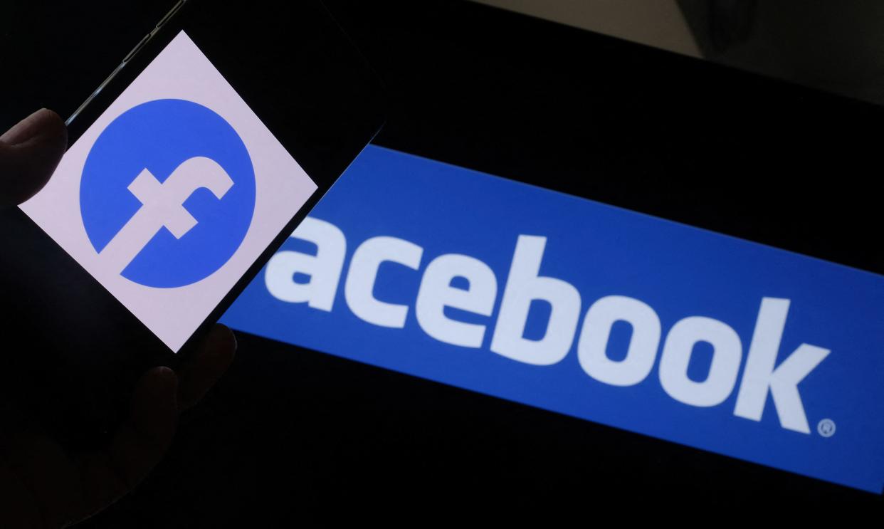 This illustration photo shows the Facebook logo on a smartphone in front of a computer screen in Los Angeles on August 12, 2021. - Google, YouTube and Facebook-Instagram have all recently bolstered defenses for teen users, while critics have been urging Facebook to abandon plans for a children's version of Instagram. (Photo by Chris DELMAS / AFP) (Photo by CHRIS DELMAS/AFP via Getty Images)