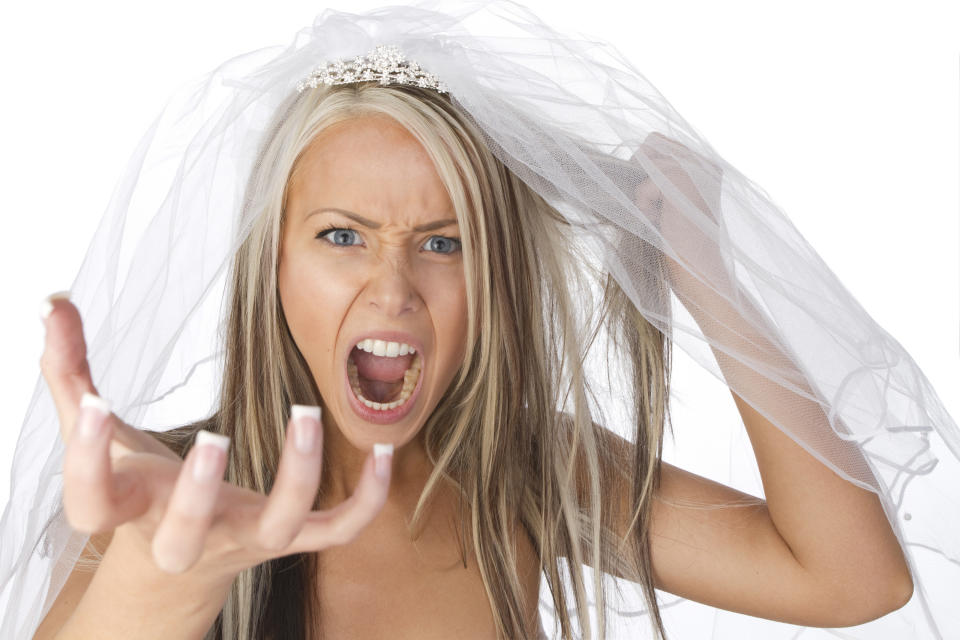 An angry bride yells while wearing her wedding veil