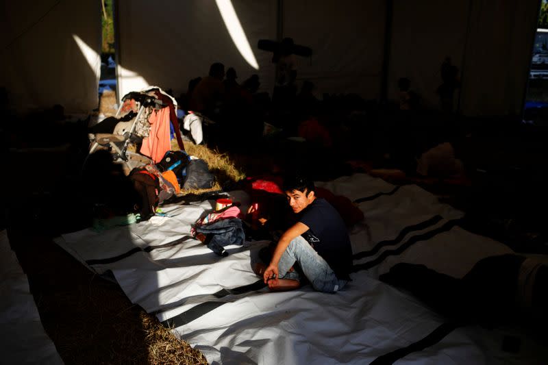 Migrants travelling to the U.S. gather in an improvised shelter in Tecun Uman