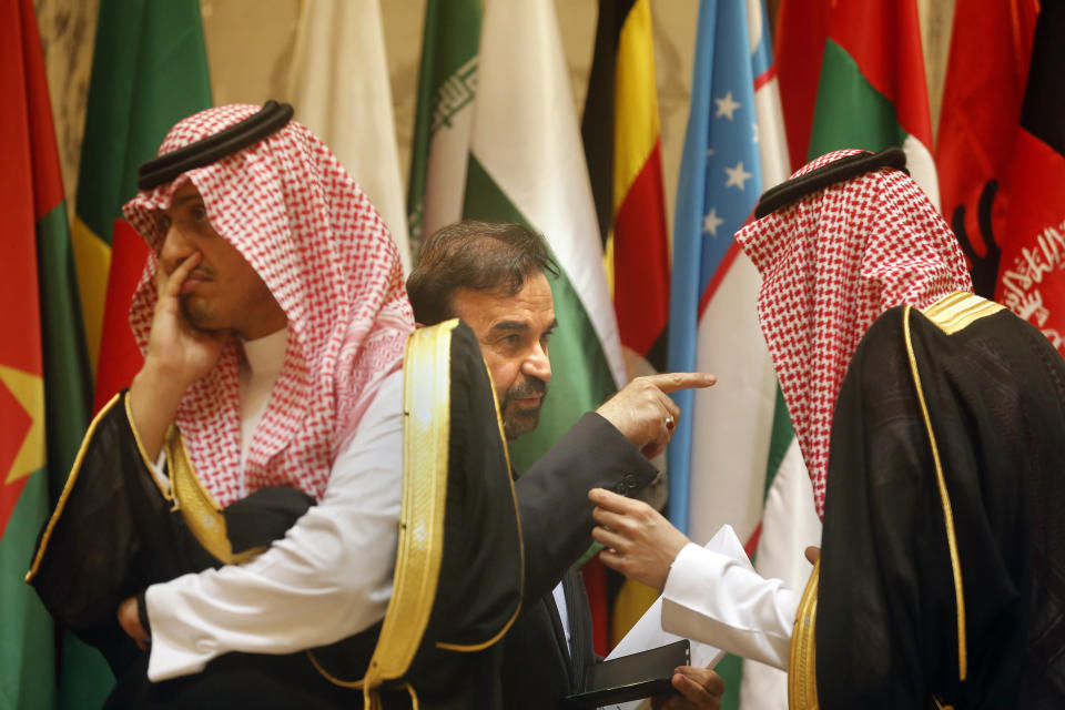 Director General of International Peace and Security Department at Iran's Foreign Ministry, Reza Najafi, center, talks to a Saudi protocol official during a group picture of leaders attending Islamic Summit of the Organization of Islamic Cooperation (OIC) in Mecca, Saudi Arabia, early Saturday, June 1, 2019. Muslim leaders from some 57 nations gathered in Islam's holiest city of Mecca late Friday to discuss a breadth of critical issues ranging from a spike in tensions in the Persian Gulf, to Palestinian statehood, the plight of Rohingya refugees and the growing threat of Islamophobia. (AP Photo/Amr Nabil)