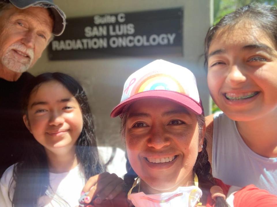 Claudia Olsen and her family outside an oncology office in San Luis Obispo. Olsen documented her journey with breast cancer on social media.