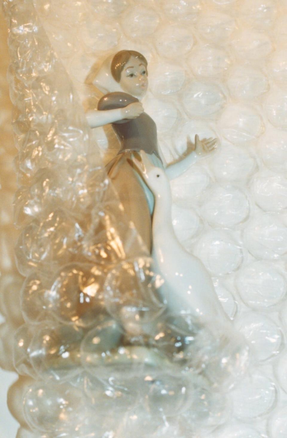 Wrapped Lladro figurine using bubble wrap.