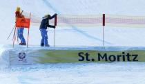 Alpine Skiing - FIS Alpine Skiing World Championships - Men's Downhill - St. Moritz, Switzerland - 11/2/17 - Course workers close the gate as race is canceled due to fog. REUTERS/Ruben Sprich