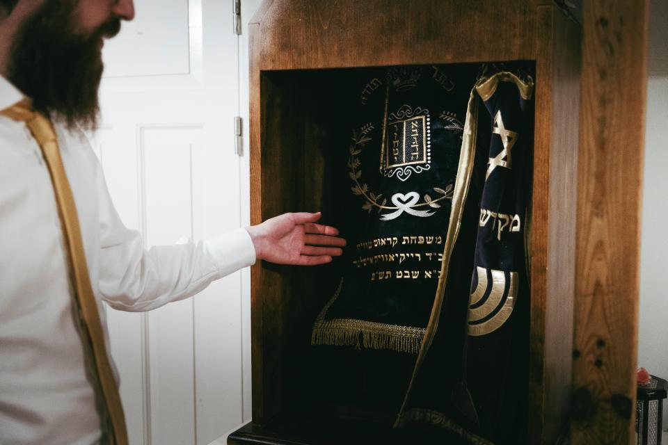 Man showing his collection of Judaica items.