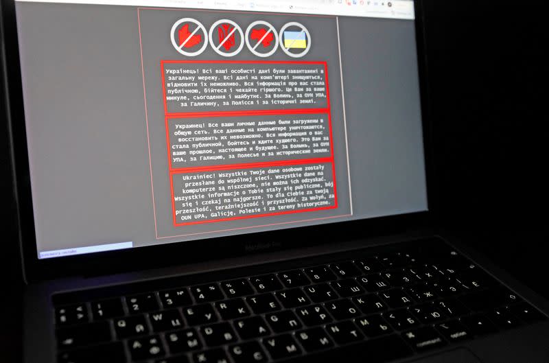 A laptop screen displays a warning message on the official website of the Ukrainian Foreign Ministry, in this illustration