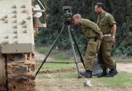 ISRAEL/GAZA BORDER, ISRAEL- NOVEMBER 19: Israeli soldiers prepare an artillery emplacement overlooking Gaza on November 19, 2012 on Israel's border with the Gaza Strip. The death toll has risen to at least 85 killed in the air strikes, according to hospital officials, on day six since the launch of operation 'Pillar of Defence.' (Photo by Christopher Furlong/Getty Images)