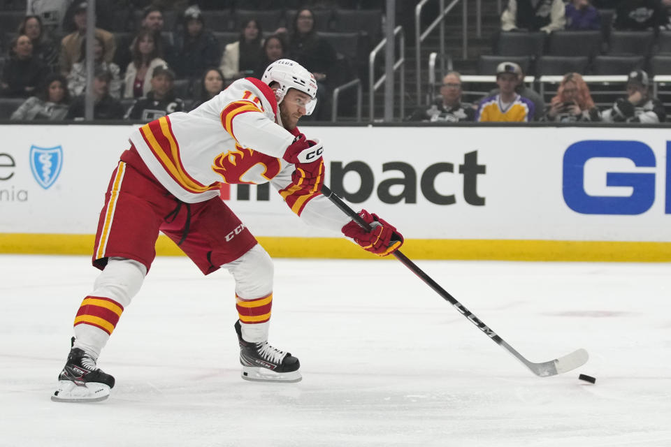 Calgary Flames center Jonathan Huberdeau (10) shoots and scores during the first period of an NHL hockey game against the Los Angeles Kings Thursday, Dec. 22, 2022, in Los Angeles. (AP Photo/Ashley Landis)