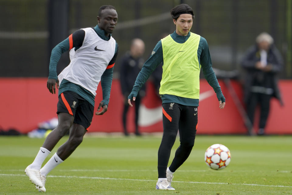 Liverpool's Sadio Mane, left, and Liverpool's Takumi Minamino challenge for the ball during a media day and training session ahead of the Champions League final at the training centre in Liverpool, England, Wednesday, May 25, 2022. Liverpool will face Real Madrid in the Champions League final in Paris, France, on Saturday May 28,2022.(AP Photo/Jon Super)