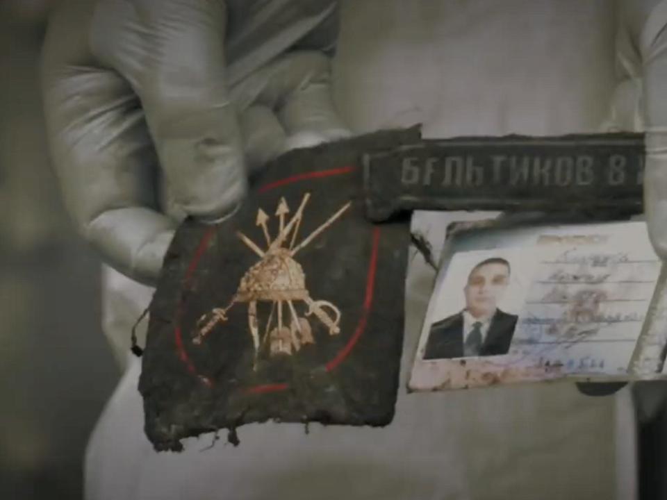 Ukrainian rail mortuary workers show Russian military identification card