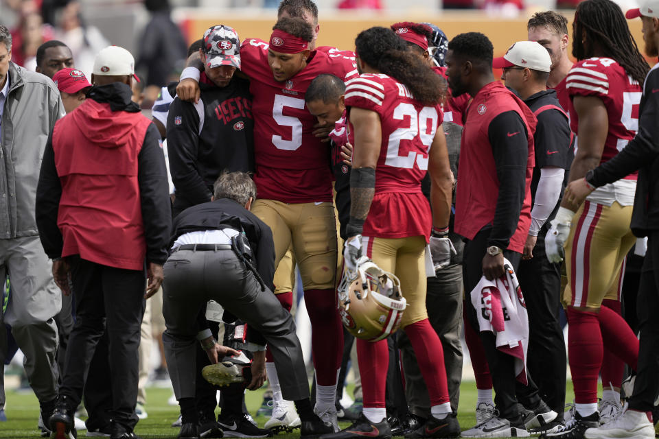 San Francisco 49ers quarterback Trey Lance (5) is helped onto a cart during the first half of an NFL football game against the Seattle Seahawks in Santa Clara, Calif., Sunday, Sept. 18, 2022. (AP Photo/Tony Avelar)