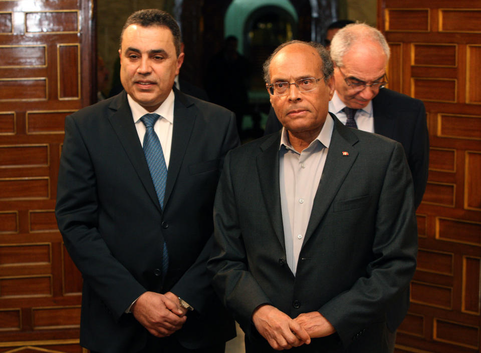 Tunisian President Moncef Marzouki, right, greets newly appointed Prime Minister Mehdi Jemaa, at Carthage Palace, in Tunis, Tunisia, Saturday, Jan. 25, 2014. The Tunisian opposition threatened Saturday to vote against the draft constitution if the incoming prime minister decides to keep the current interior minister in his cabinet. (AP Photo/Hassene Dridi)