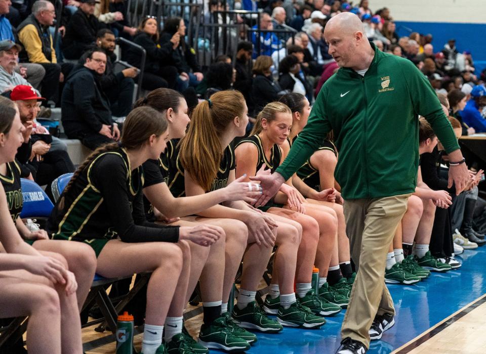 Archbishop Wood's head coach Mike McDonald, right, hi-fives the bench in celebration of their win against Bethlehem Catholic during their PIAA Class 5A girls’ state semifinal basketball game in Norristown on Tuesday, March 19, 2024.