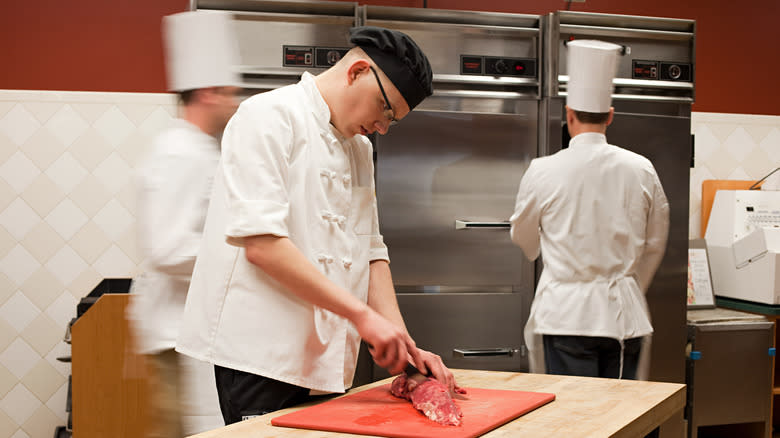 chef walking behind cook