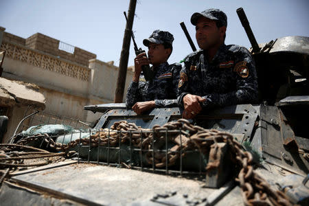 Members of the Iraqi Federal Police are seen on an armoured vehicle during clashes with Islamic State fighters in western Mosul, Iraq May 27, 2017. REUTERS/Alkis Konstantinidis