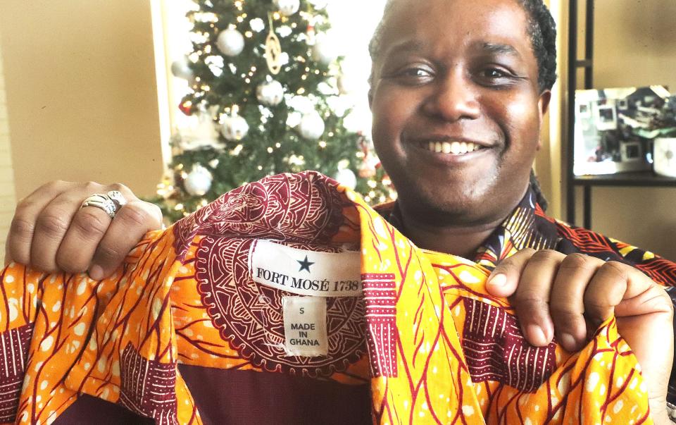 Daytona Beach native Maurice Gattis holds a man's jacket with his label for Fort Mose 1738, a new fashion company that he started in partnership with a couple from Ghana. The name is a nod to Fort Mose in St. Augustine, the historic site of the first free Black community in the United States.