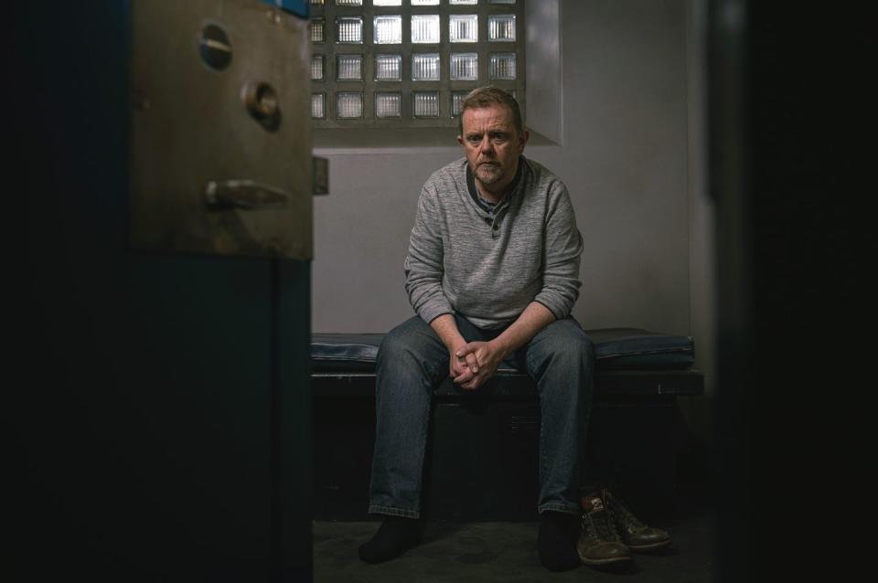 dan spencer in a cell in emmerdale after arrest for punching lloyd