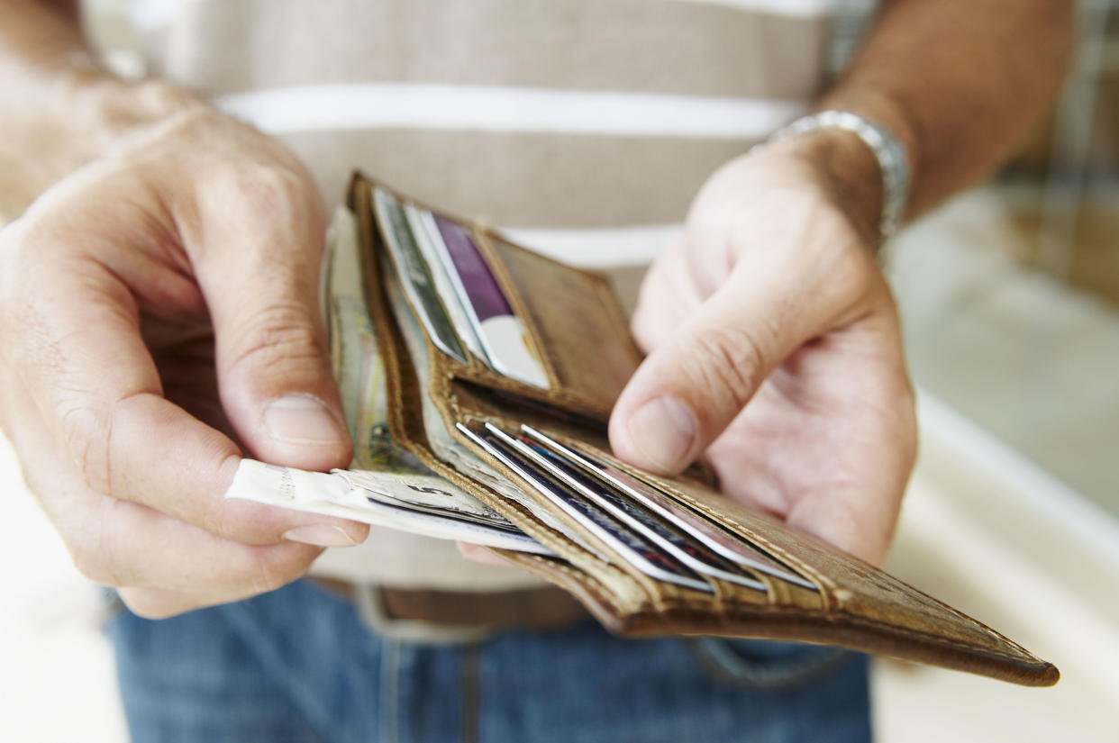 Man removes cash from wallet