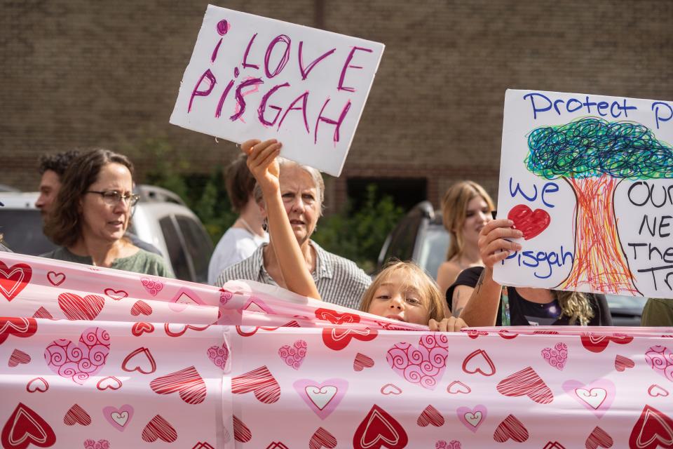 Maple, age 8, holds a sign at the Protect Pisgah Party and Rally outside of the National Forests in North Carolina's Forest Supervisor's office in Asheville on August 1, 2022.