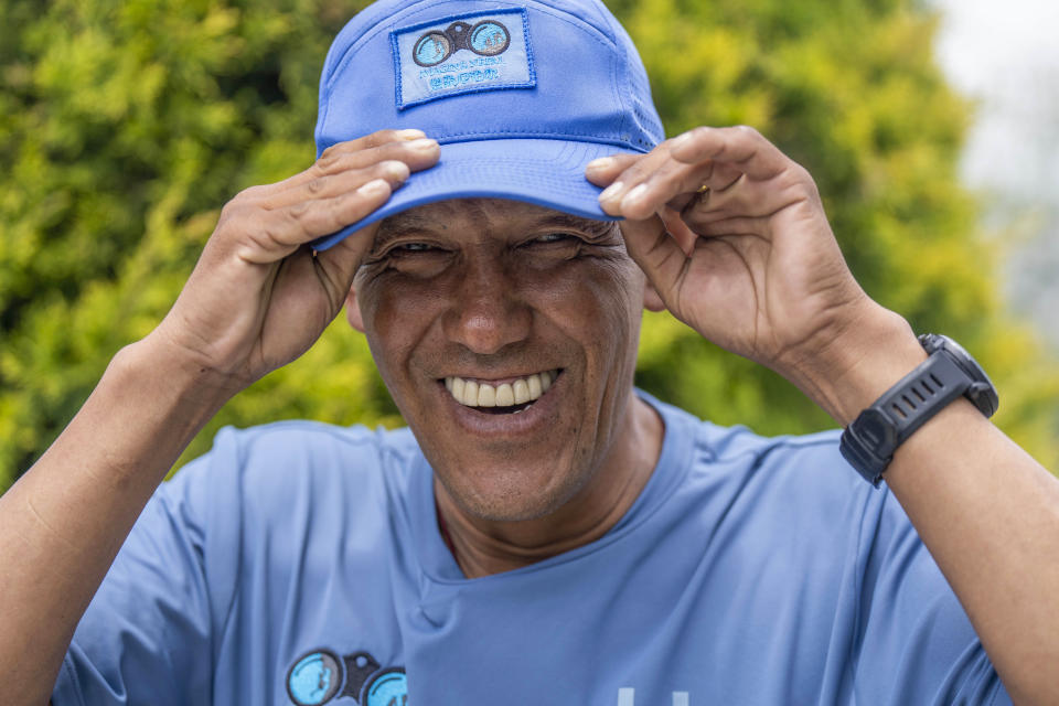 Sherpa guide Pasang Dawa, 48, adjusts his hat as he poses for a photograph during an interview with the Associated Press in Kathmandu, Nepal, Thursday, June 15, 2023. Pasang Dawa, plans to climb the 8,849-meter (29,032-foot) high Mount Everest next year in an attempt to again match the record set by a fellow Sherpa guide. (AP Photo/Niranjan Shrestha)