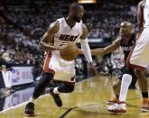 Miami Heat's Dwyane Wade, left, drives as Charlotte Bobcats' Gerald Henderson, right, defends during the first half in Game 2 of an opening-round NBA basketball playoff series, Wednesday, April 23, 2014, in Miami. (AP Photo/Lynne Sladky)