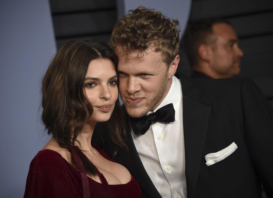 Emily Ratajkowski and Sebastian Bear-McClard pose for a photo with their cheeks touching