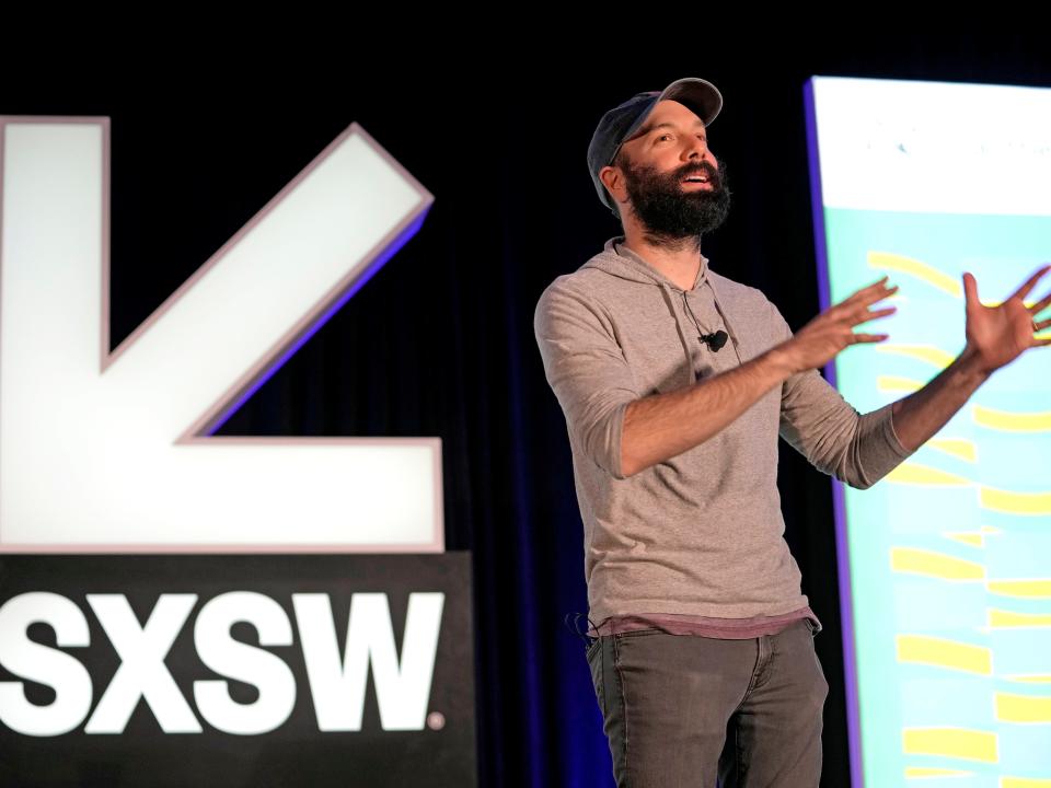 Jack Conte speaks about creators at South By Southwest in 2022 wearing grey hoodie and baseball cap.