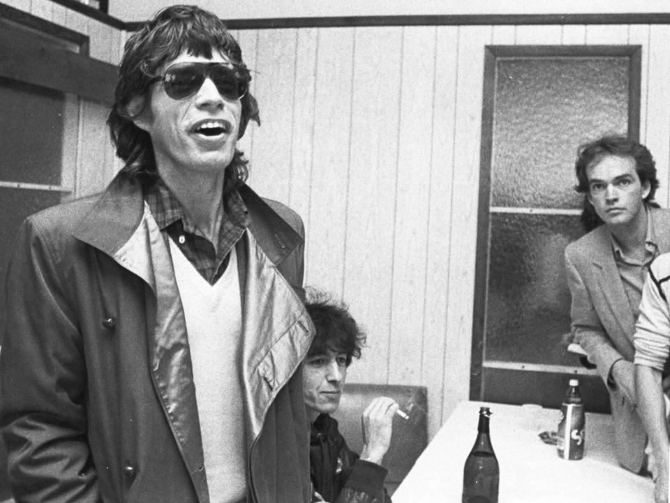 Mick Jagger, left, and Bill Wyman, seated of the Rolling Stones giving a press conference on Sept. 24, 1981, at the Worcester Airport with Worcester Telegram reporter Robert P. Connolly, far right, listening in.