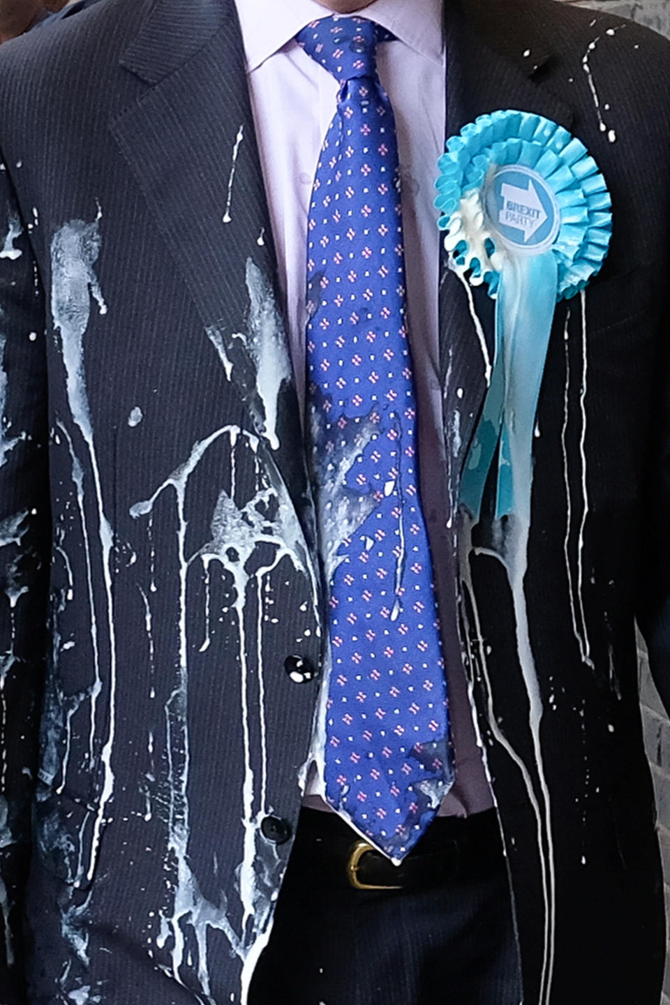 NEWCASTLE-UPON-TYNE, ENGLAND - MAY 20: Brexit Party leader Nigel Farage (R) has what is thought to have been a milkshake thrown over him as he visits Northumberland Street in Newcastle Upon Tyne during a whistle stop UK tour on May 20, 2019 in Newcastle Upon Tyne, England. His visit to Newcastle comes ahead of the 2019 European elections in the United Kingdom which will take place on May 23. The Brexit Party, a pro-Brexit Eurosceptic political party formed in 2019, is reported to be polling in front of Labour and the Conservatives for the European parliament elections. (Photo by Ian Forsyth/Getty Images)