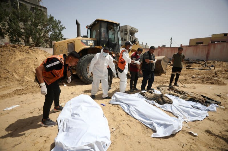 On Wednesday, teams continue to remove the decomposed and dismembered bodies of Palestinians who lost their lives after Israeli attacks in Khan Yunis southern Gaza. The United Nations has called for an “independent, effective and transparent investigation” into the discovery of mass graves at two Gaza hospitals that were besieged and raided by Israeli troops this year. The discovery came after Israel troops left Khan Yunis. Photo by Ismael Mohamad/UPI