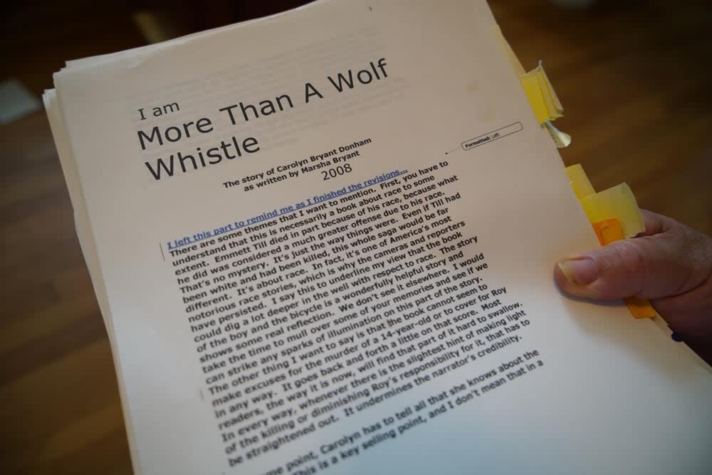 Author Timothy Tyson looks at a copy of Carolyn Bryant Donham’s memoir in his home in Durham, N.C., on Thursday, July 14, 2022. (AP Photo/Allen G. Breed)