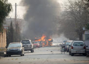 <p>Vehicles are seen on fire after a blast in Jalalabad, Afghanistan, Jan. 24, 2018. (Photo: Parwiz/Reuters) </p>