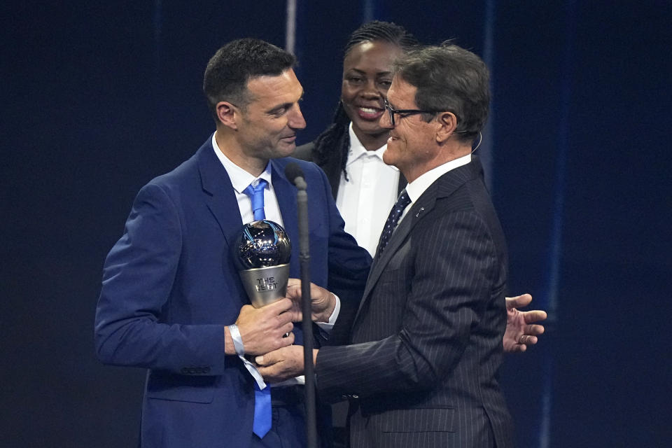 Argentina's coach Lionel Scaloni, left, receives the Best FIFA Men's Coach award from Italian coach Fabio Capello during the ceremony of the Best FIFA Football Awards in Paris, France, Monday, Feb. 27, 2023. (AP Photo/Michel Euler)